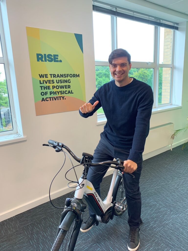 Rise team member on an electric bike